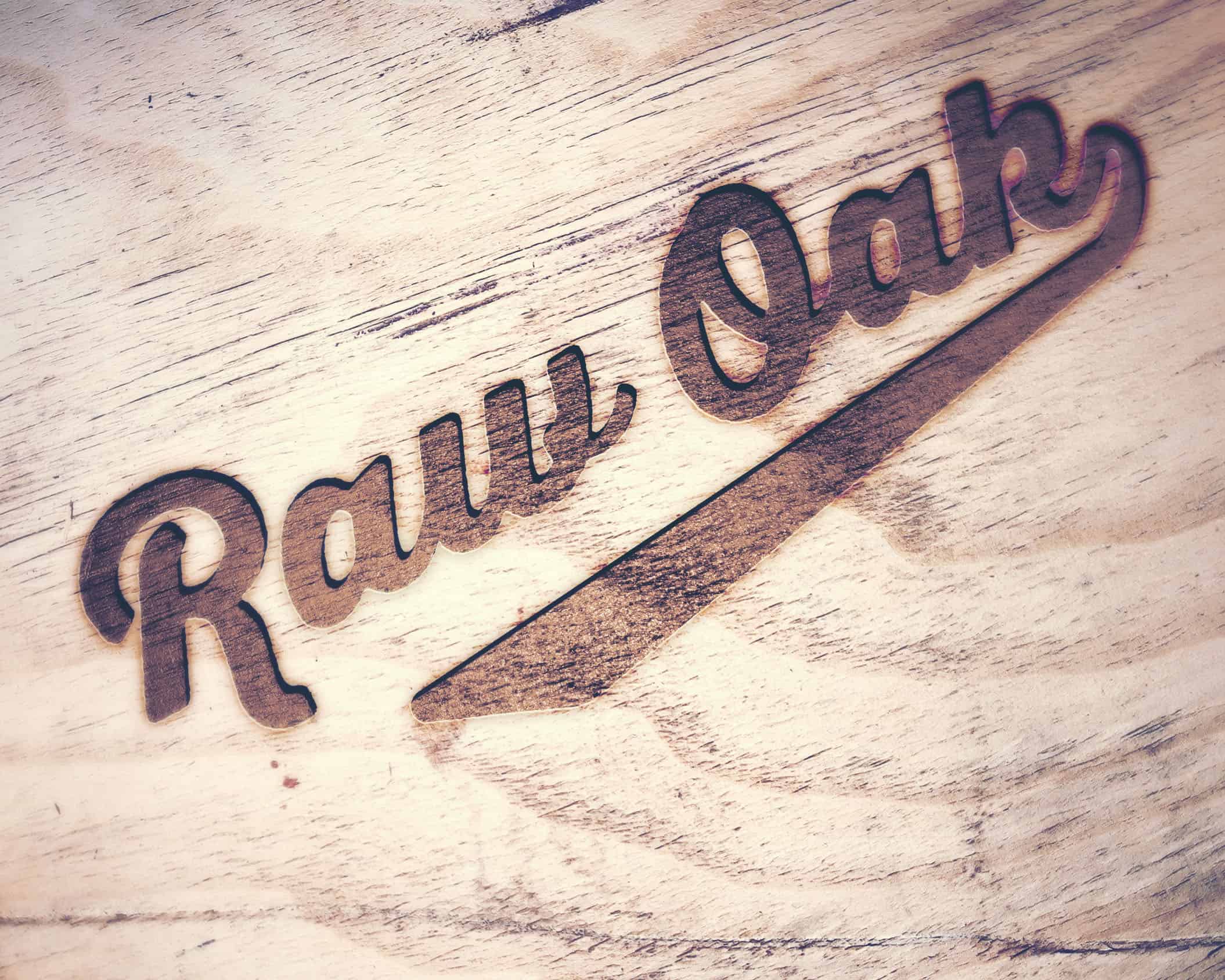 raw oak logo branding on wood surface